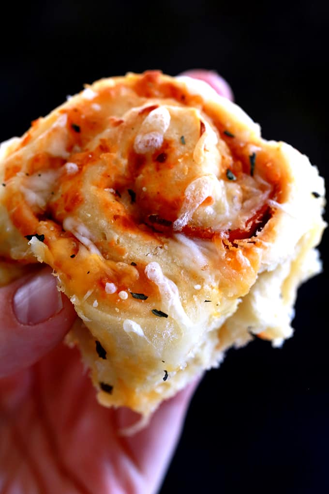 These Pepperoni Pizza Rolls are absolutely nothing like anything you can find in the grocery store freezer section. A fluffy, homemade brioche bread dough is layered with pizza sauce, garlic, pepperoni, mozzarella cheese and basil before being cut into rolls. After baking, they're sprinkled with even more cheese and basil to create these addictive rolls.