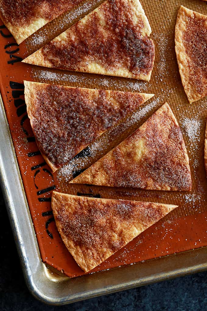 These Turtle Churro Nachos are the perfect dessert to feed a crowd. Homemade cinnamon and sugar speckled tortilla chips are drizzled with caramel sauce and chocolate ganache before being crowned with a dollop of caramel cream cheese. They're then sprinkled with chopped pecans and additional cinnamon sugar. 