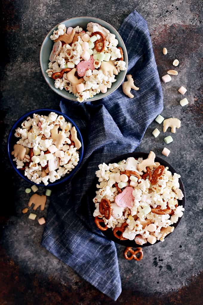 This Animal Cookie Snack Mix is popular with young and old alike.  Freshly popped popcorn is tossed with animal crackers, frosted animal cookies, miniature fruit marshmallows, mini pretzels and peanuts for the perfect sweet and savory snack mix.  