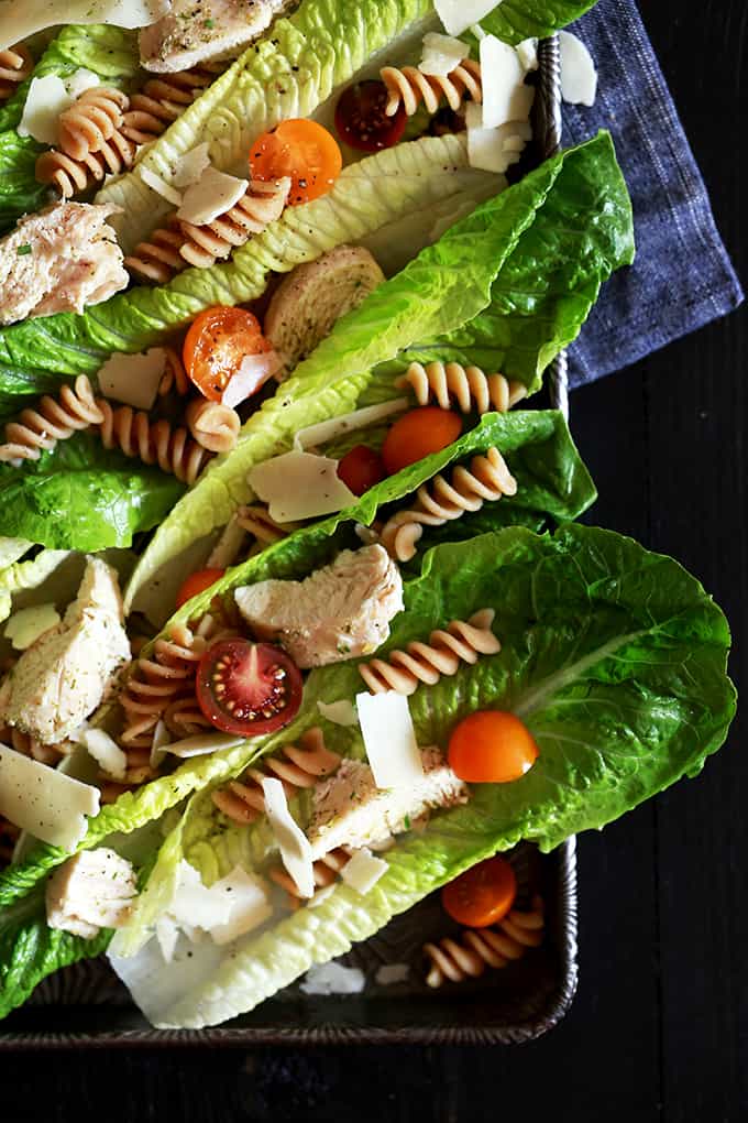 This deliciously easy Chicken Caesar Pasta Salad takes just 25 minutes to prepare and is the perfect weeknight dinner idea. Â Chicken, shaved Parmesan cheese, pasta and cherry tomatoes adorn crisp romaine leaves before being drizzled with a homemade Caesar dressing.