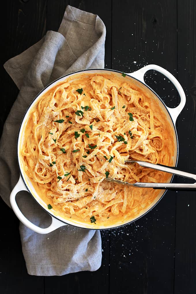 This eight ingredient Skinny Pumpkin Alfredo Sauce uses common pantry and fridge ingredients which means you can enjoy it any day of the week without making a special trip to the grocery store.  Garlic, Parmesan cheese, chicken broth and Greek yogurt are thickened into an amazing creamy sauce.  Once you stir in pumpkin puree and a sprinkle of ground nutmeg, well, an autumn pasta favorite is born.