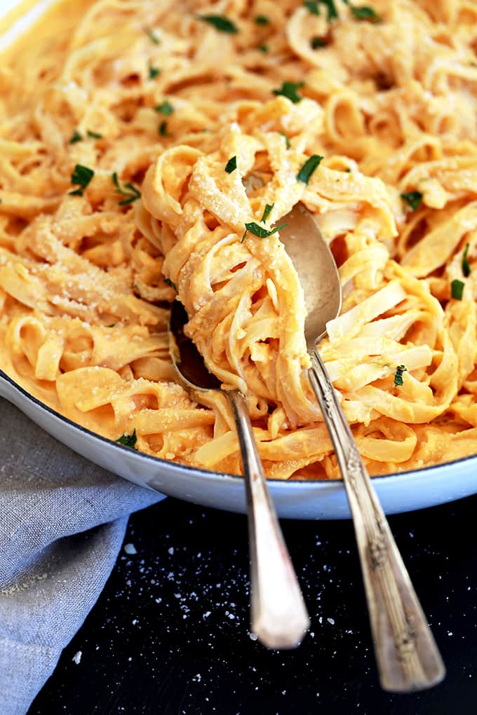 This eight ingredient Skinny Pumpkin Alfredo Sauce uses common pantry and fridge ingredients which means you can enjoy it any day of the week without making a special trip to the grocery store.  Garlic, Parmesan cheese, chicken broth and Greek yogurt are thickened into an amazing creamy sauce.  Once you stir in pumpkin puree and a sprinkle of ground nutmeg, well, an autumn pasta favorite is born.