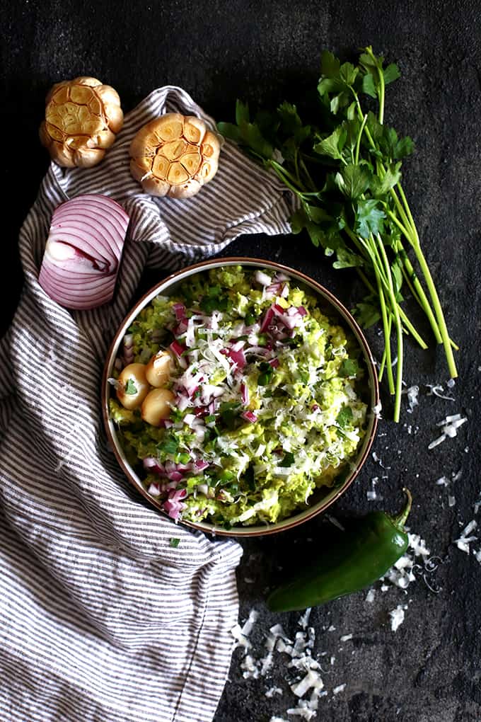 This Pecorino Guacamole begins with roasted garlic, red onion and jalapeño that are mashed with fresh avocado before being showered with Pecorino Romano cheese. This easy guacamole recipe is then seasoned with salt and pepper and garnished with additional onion, jalapeño, parsley and a drizzle of agave nectar. This Pecorino Guacamole begins with roasted garlic, red onion and jalapeño that are mashed with fresh avocado before being showered with Pecorino Romano cheese. This easy guacamole recipe is then seasoned with salt and pepper and garnished with additional onion, jalapeño, parsley and a drizzle of agave nectar.