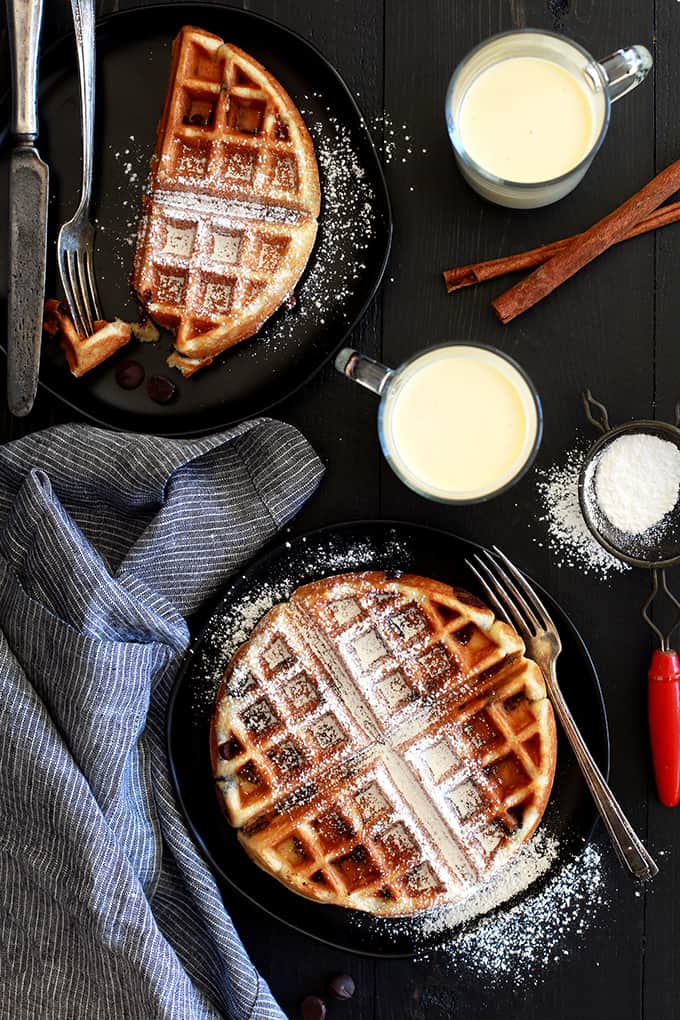 Cinnamon, vanilla, nutmeg and cloves provide the holiday flavor in these Chocolate Chip Eggnog Waffles.  But all of that delicious flavor doesn't mean extra work for you!  The eggnog provides all the flavor while the addition of yogurt to this breakfast treat makes for a waffle that's crips on the outside and light and fluffy on the inside.  Then you stir in a mountain of dark chocolate chips and, well, they're just what waffle dreams are made of!