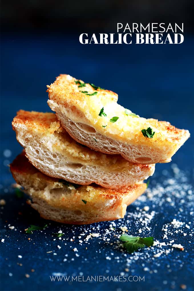 This six ingredient Parmesan Garlic Bread is ready to become a mainstay in your kitchen.  A loaf of French bread from your grocery store's bakery is halved and then topped with a mixture of olive oil, butter, garlic and grated Parmesan cheese and then showered with chopped fresh parsley.