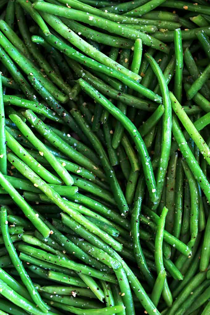 These Garlic Butter Green Beans are the perfect ace to have up your sleeve to serve with just about anything.  Using just three ingredients and taking only 20 minutes from start to finish, fresh green beans are trimmed and simmered until crisp tender before being bathed in butter and fresh garlic and seasoned with salt and pepper. #sidedish #greenbeans #garlic #butter