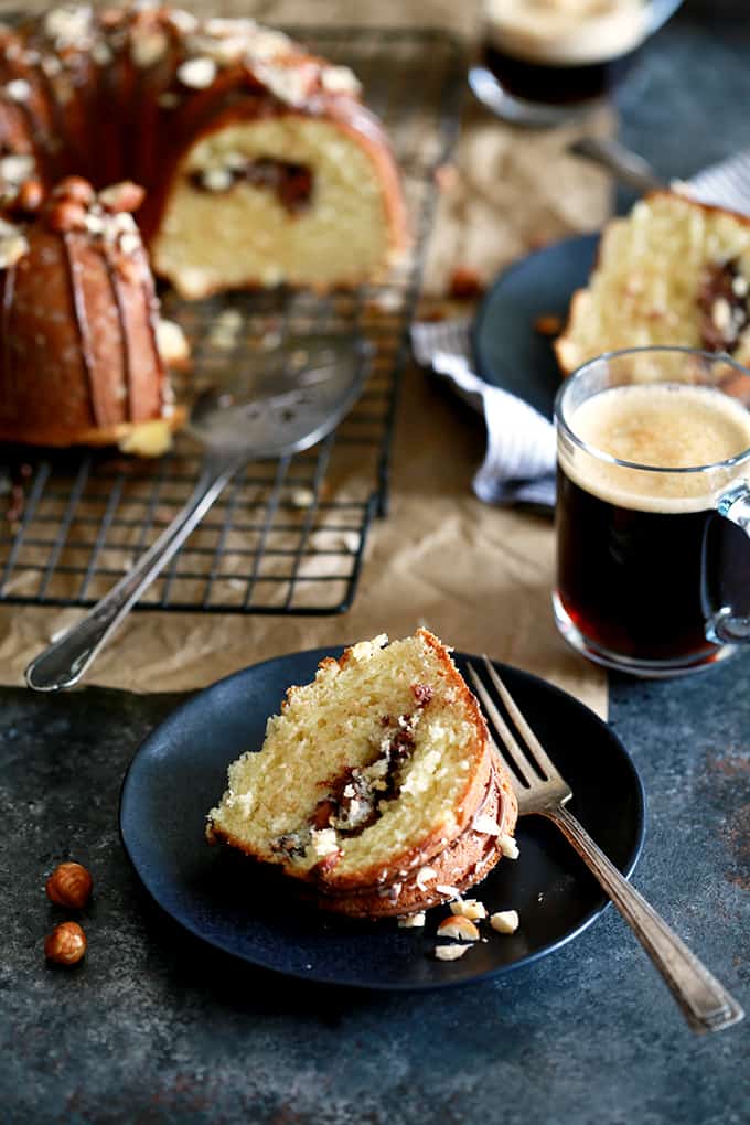 An entire cup of sour cream in this Nutella Sour Cream Coffee Cake insures a tender end result.  Not only does this cake feature a tunnel of Nutella and chopped hazelnuts throughout the inside of the cake, but the finished cake is also garnished with drizzled Nutella and more chopped hazelnuts.  In other words, it's heaven in coffee cake form.   