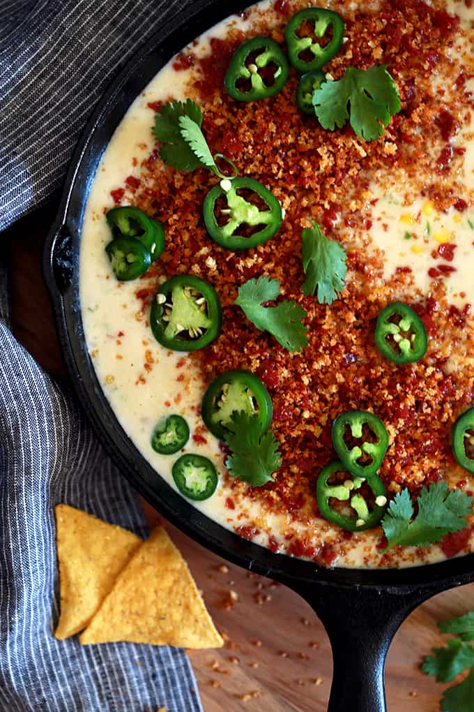 ThisÂ Sweet Corn Queso with Pepperoni Crumbs literally comes together by just stirring ingredients together with a spoon in a cast iron skillet.Â  Red onion, garlic, jalapeÃ±o and corn are stirred into Monterey Jack cheese to create this incredible queso that's garnished with the mostÂ insanely delicious pepperoni crumbs, cilantro and jalapeÃ±os.