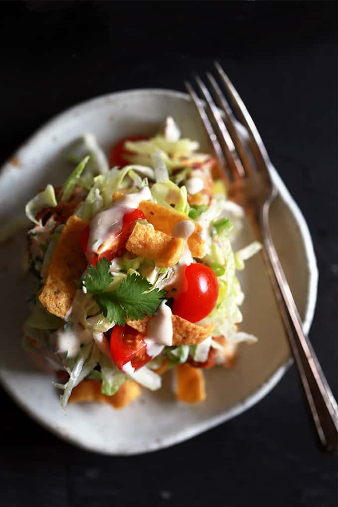 What makes my Taco Bubble Pizza a dinner favorite?  Topped with all the usual taco suspects - ground beef, taco sauce, shredded lettuce, tomatoes, green onions - there's also two toppings which make my Taco Bubble Pizza stand out from the crowd.  You'll no doubt love the crunch of corn chips and homemade chipotle yogurt sauce on this mashup recipe.