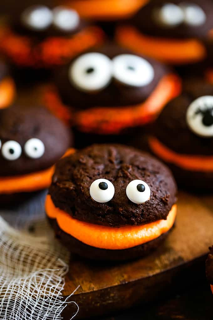 Mini Monster Chocolate Whoopie Pies sit on a wooden surface.