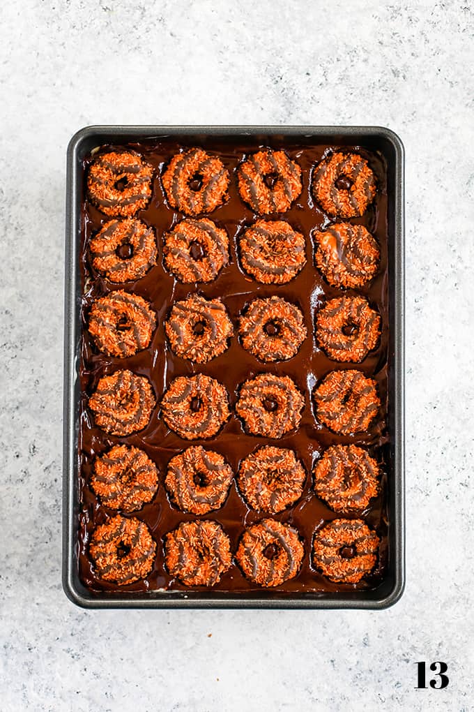 This decadent Samoa Brownies recipe has it all! Fudgy brownie, two layers of Samoa Girl Scout cookies, dulce de leche, coconut and chocolate ganache. #brownies #chocolate #cookies #caramel #coconut #desserts How to prepare Samoa Brownies, step 13.