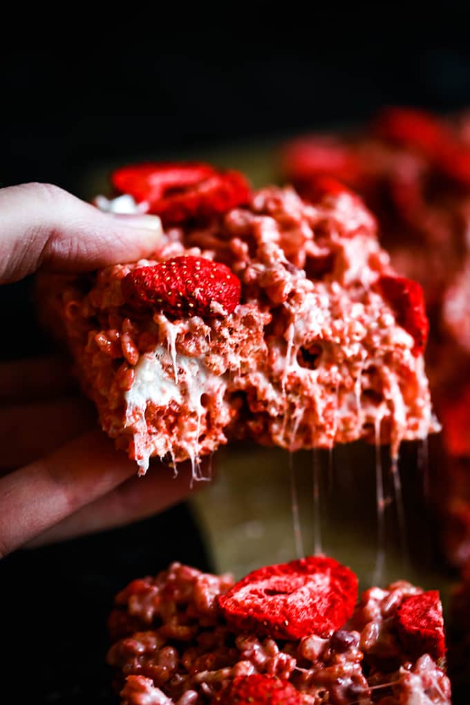 A hand holds a Strawberry Rice Krispie Treat.